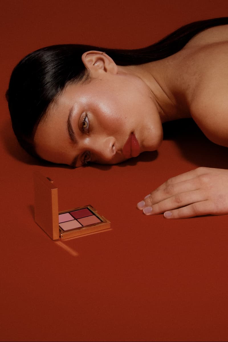 woman laying down next to the new les filles en rouje la charme palette, new makeup, french beauty
