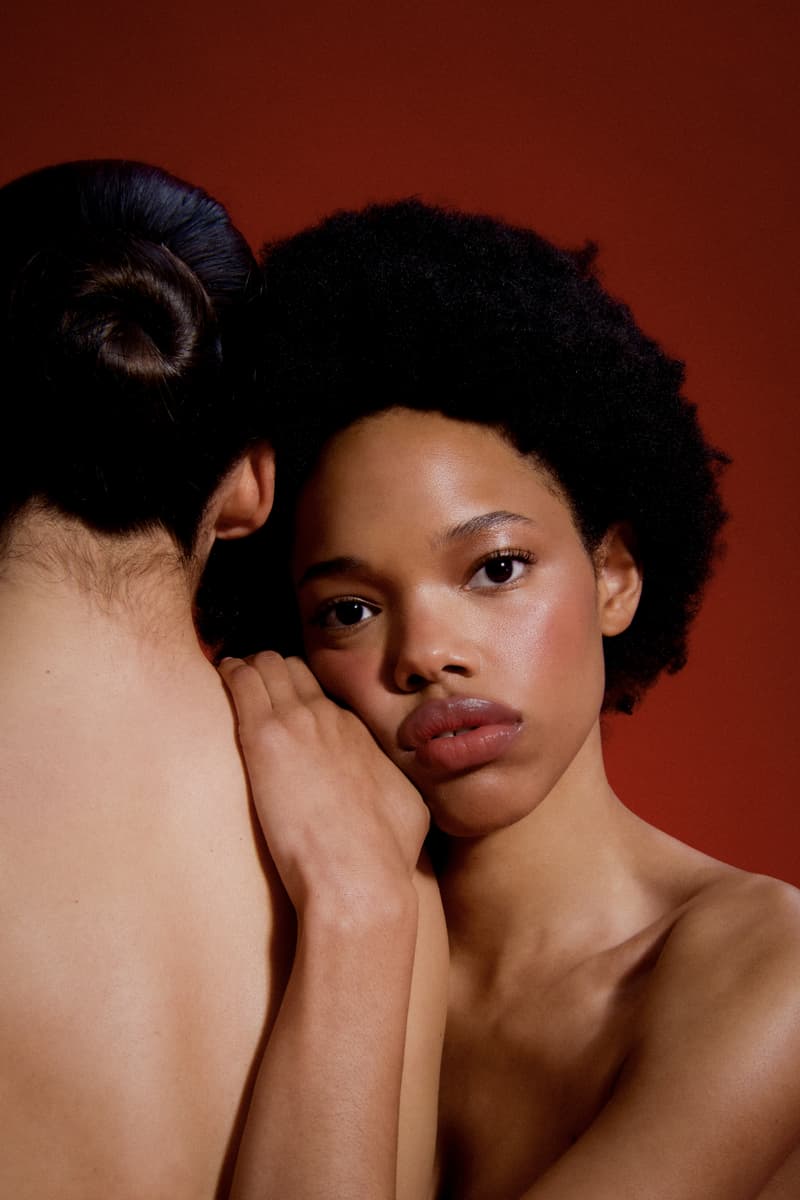 woman laying down next to the new les filles en rouje la charme palette, new makeup, french beauty