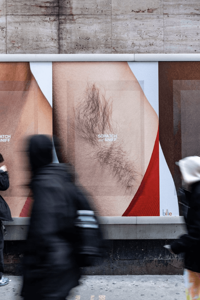 people passing by a billboard of armpits billie body care, deodorant, beauty, skincare 
