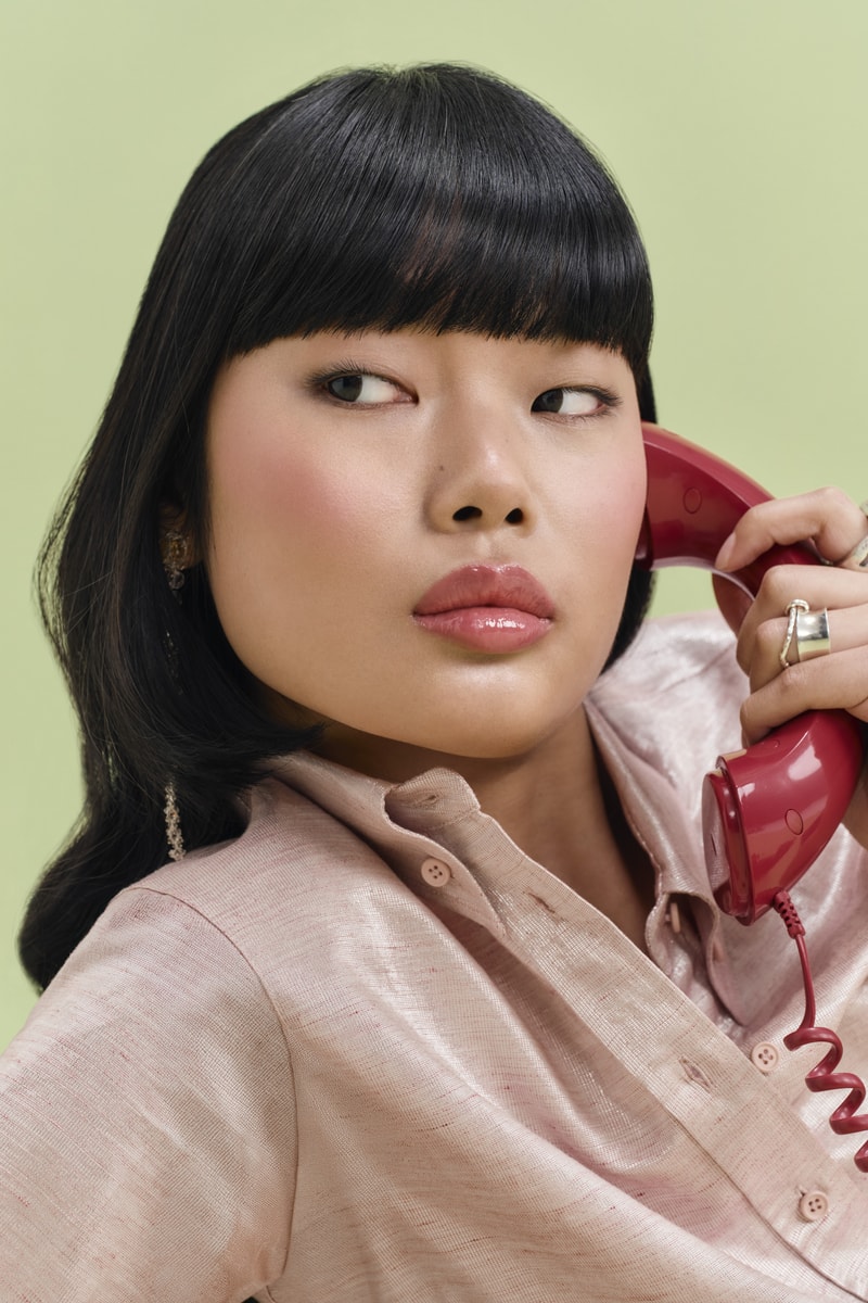 woman licking lollipop, eadem chou chou lip balm in guava fresca skincare makeup beauty