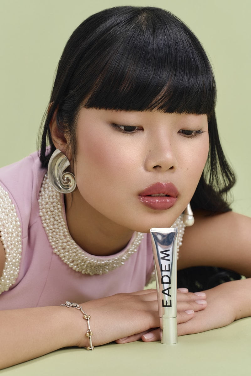 woman licking lollipop, eadem chou chou lip balm in guava fresca skincare makeup beauty