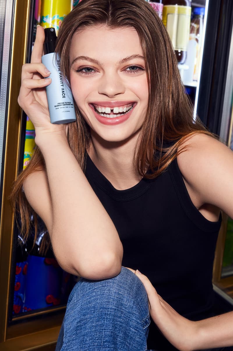 woman in the subway spraying skincare mist on her face, sofie pavitt skincare, beauty 