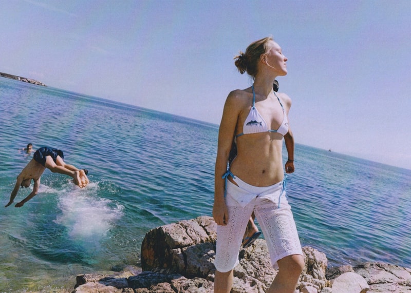 fruity booty, swimwear, bikinis, fish prints, sea, woman, girl, lying down, on the beach
