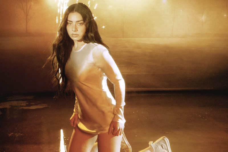 charli xcx, converse, white sneakers, girl laying, singer