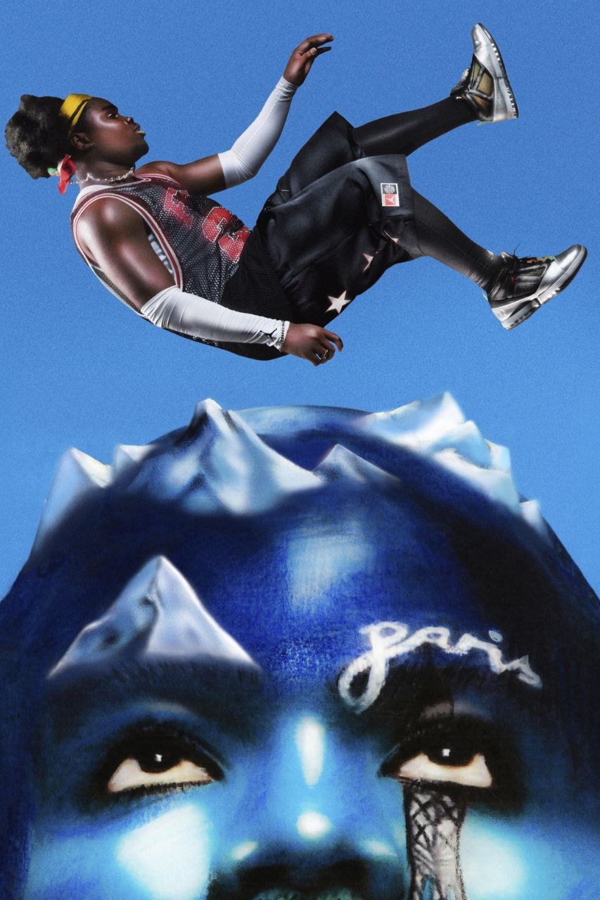 A Free The Youth campaign figure suspended above a sculpted blue face