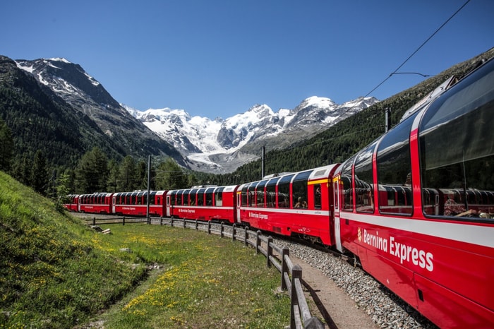 Crossing 196 bridges to reach Italy, this red train turns the Alps into a movie