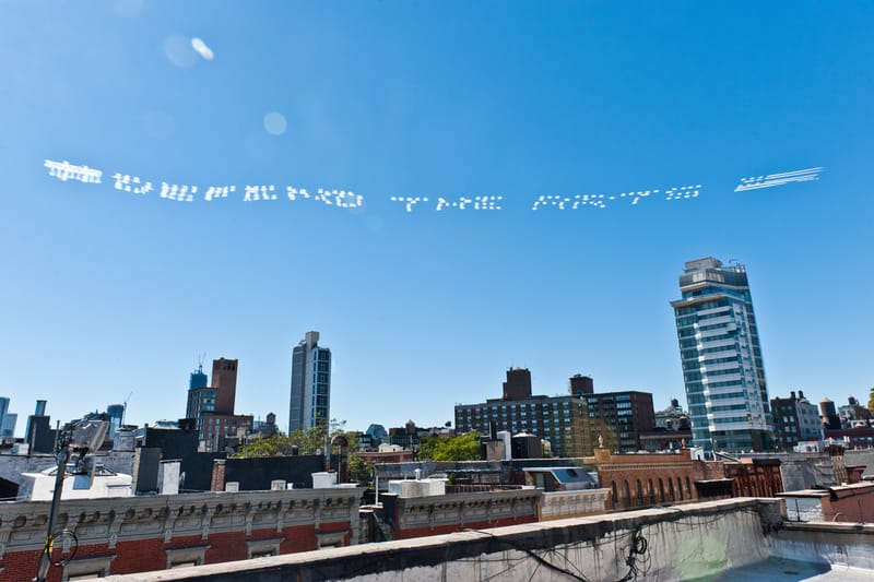 Saber #ARTISNOTACRIME Skywriting Project Over NYC