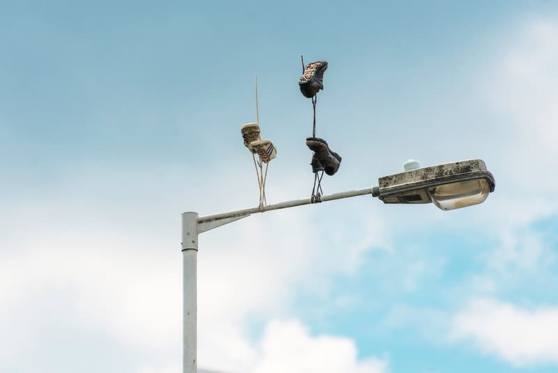 Street Artist Pejac Downside Up Hanging Sneakers