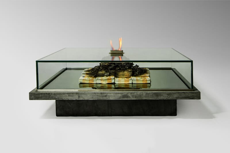 This Glass Coffee Table Features a Large Heap of Burning Money