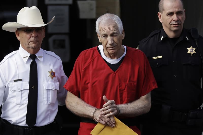 jerry sandusky penn state handcuffs jail court trial