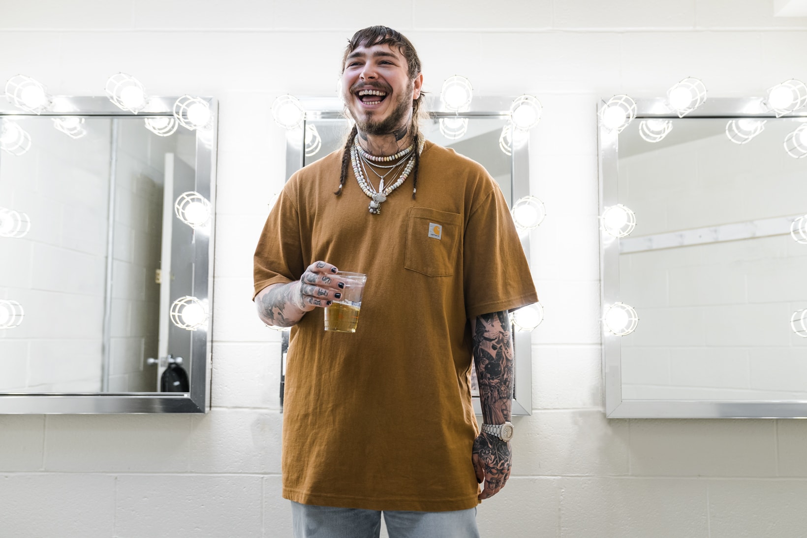 Post Malone Haircut WWE Aspirations Trance Acid Polka Album Stoney Congratulations White Iverson Deja Vu backstage performance carhartt jewelry stage clothing style fashion outfit beer beerbongs bentleys