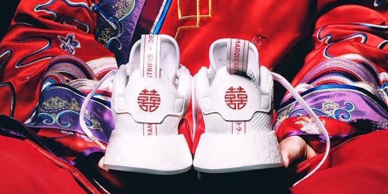 white adidas shoes with chinese writing