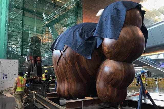 KAWS Teases Humongous 'SMALL LIE' Companion Sculpture in Qatar
