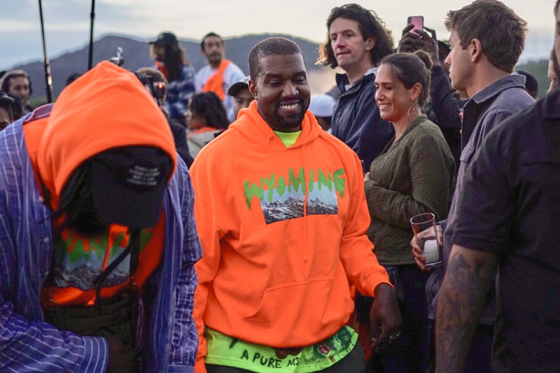 kanye-west-wyoming-album-listening-party-merch-orange-hoodie-yellow-painted-tee-shirt-black-hat
