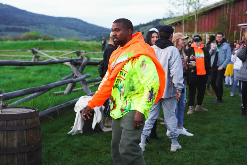 kanye-west-wyoming-album-listening-party-merch-orange-hoodie-yellow-painted-tee-shirt-grey-pants