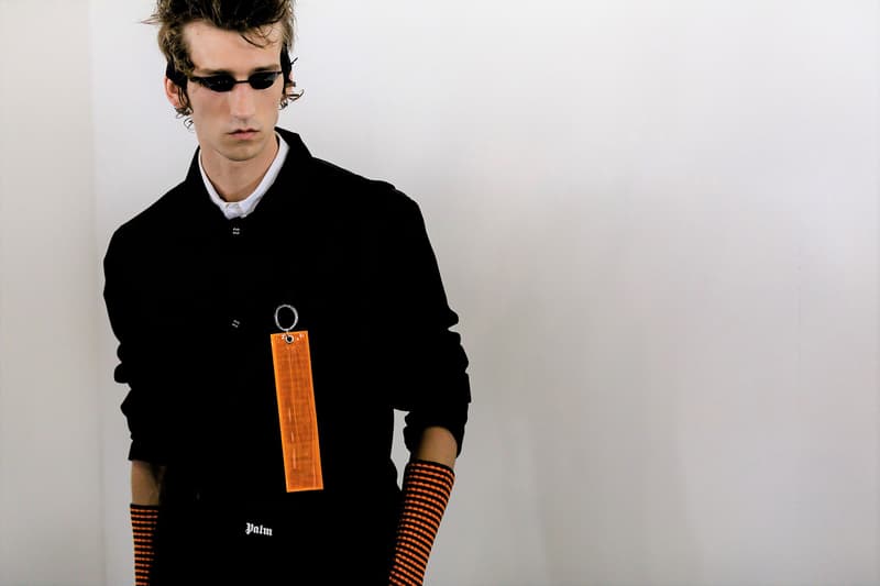 palm angels spring summer 2019 milan fashion week black shirt orange tag tanning bed glasses arm warmers belt logo