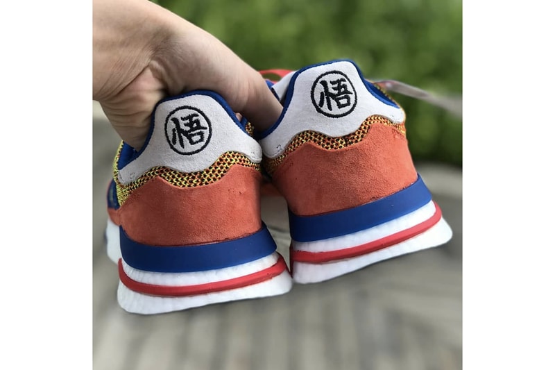 dragon ball z adidas goku collaboration zx 500 rm sneaker orange navy suede nimbus cloud boost midsole go symbol logo insignia heel ankle mesh laces orange navy back rear heel