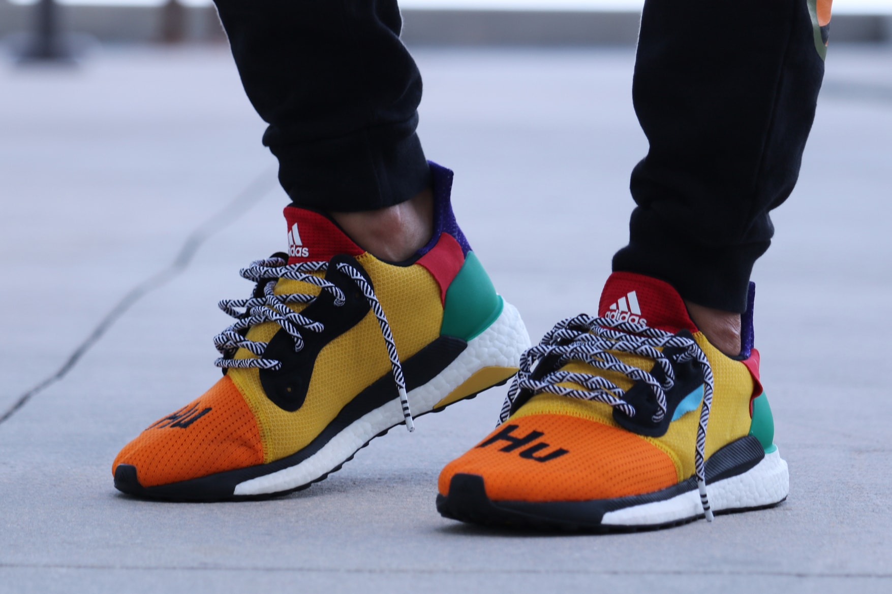 Pharrell adidas Solar Hu Glide ST Early Look rainbow colorway boost midsole yellow orange blue pink black white green pattern laces collaboration drop on foot side black