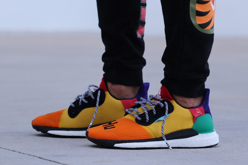 Pharrell adidas Solar Hu Glide ST Early Look rainbow colorway boost midsole yellow orange blue pink black white green pattern laces collaboration drop on foot side black