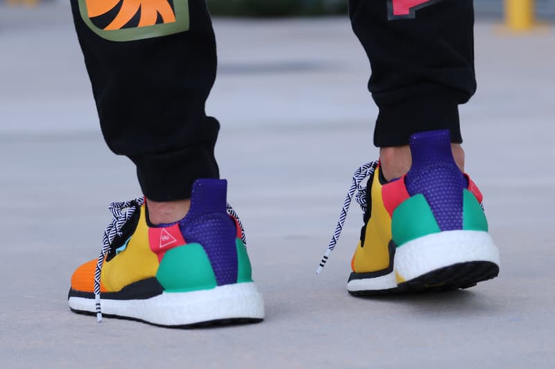 Pharrell adidas Solar Hu Glide ST Early Look rainbow colorway boost midsole yellow orange blue pink black white green pattern laces collaboration drop on foot side black