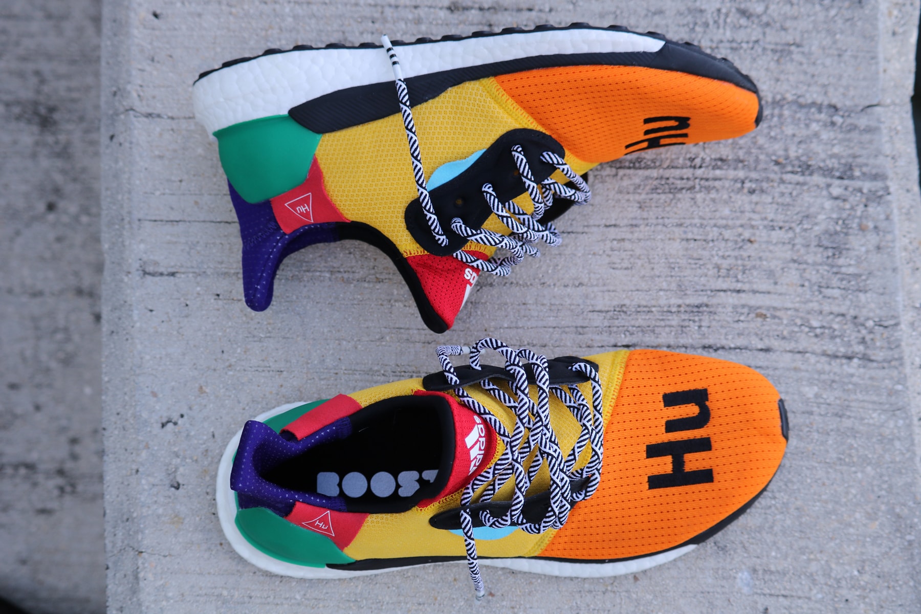 Pharrell adidas Solar Hu Glide ST Early Look rainbow colorway boost midsole yellow orange blue pink black white green pattern laces collaboration drop on foot side black