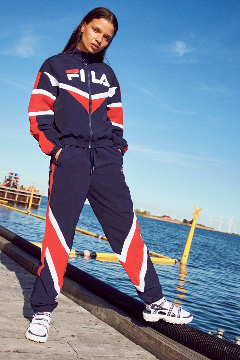 FILA Debuts Exclusive FW19 Heritage Collection  red blue track suits pants jaket drawstring stripe sandal puffer orange trek shoes jeans green red bucket hat jersey track pants italy stripe black bag caryall
