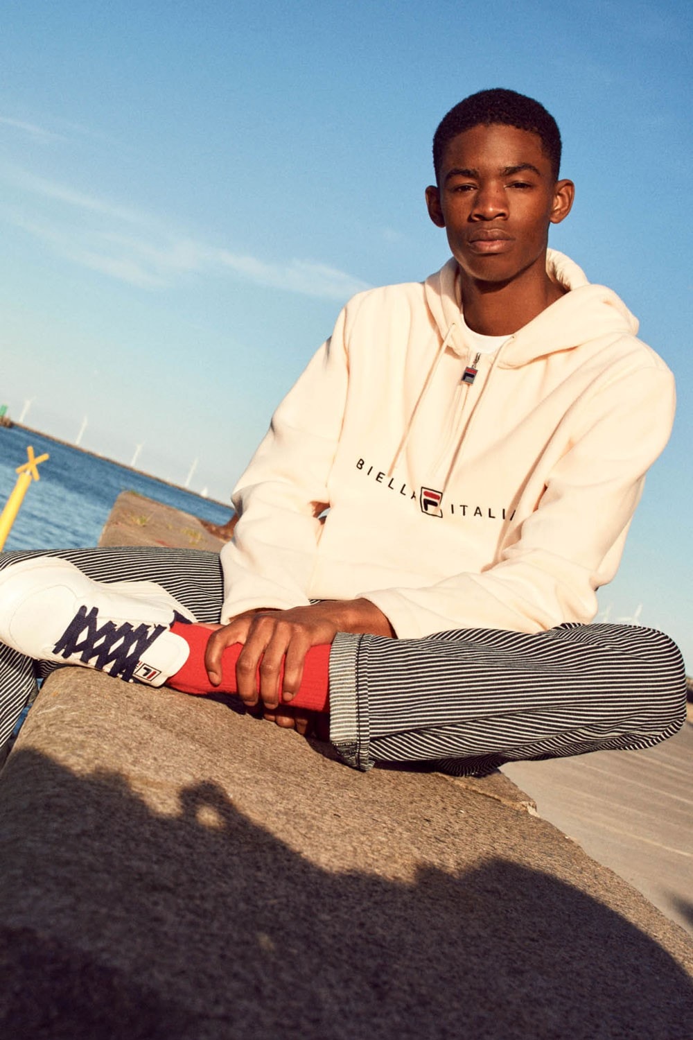 FILA Debuts Exclusive FW19 Heritage Collection  red blue track suits pants jaket drawstring stripe sandal puffer orange trek shoes jeans green red bucket hat jersey track pants italy stripe black bag caryall