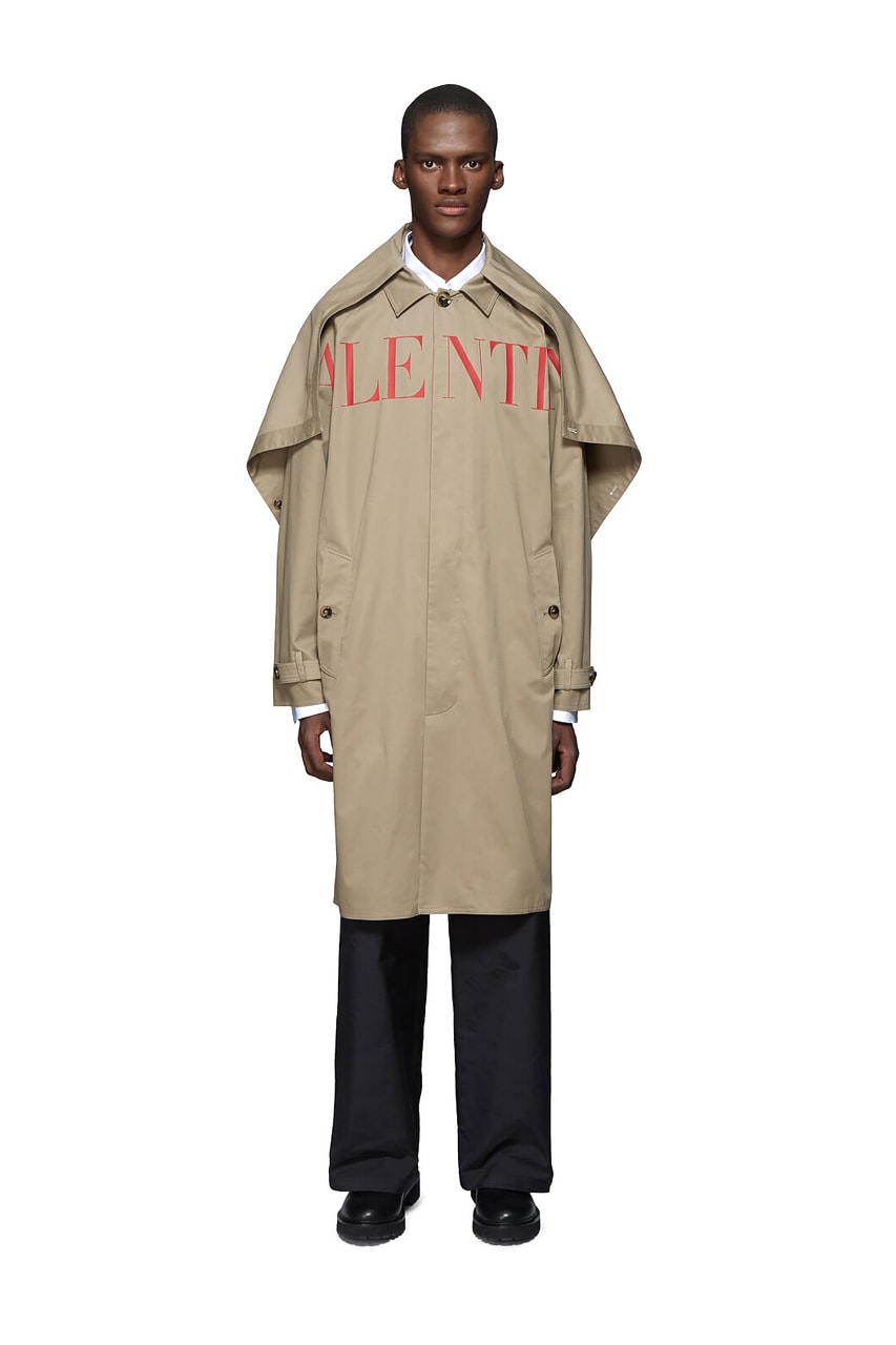 Valentino Time Traveller Coat in Black Logo Trench Coat in Beige graphics ufo flying saucers white red serif font undercover cape concealed central opening 