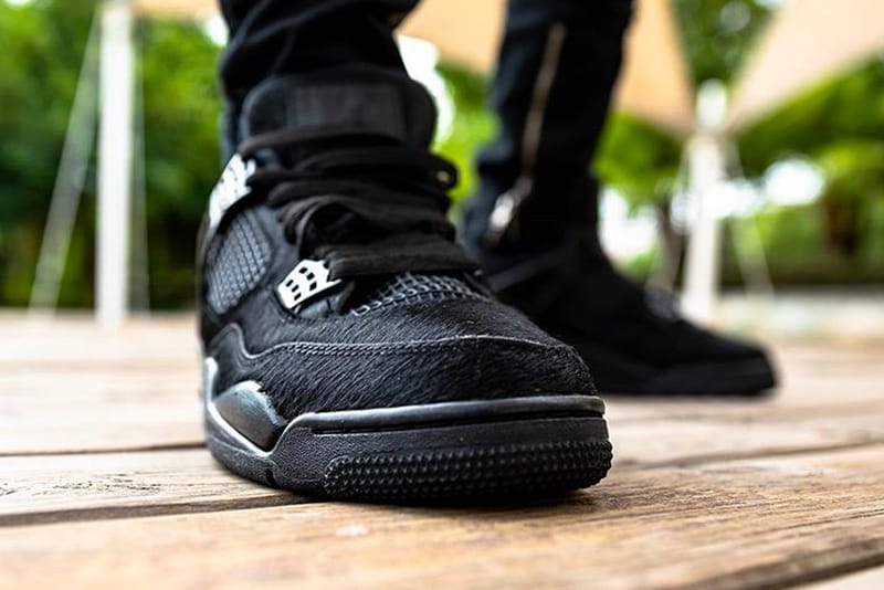 black cat jordan 4 on feet