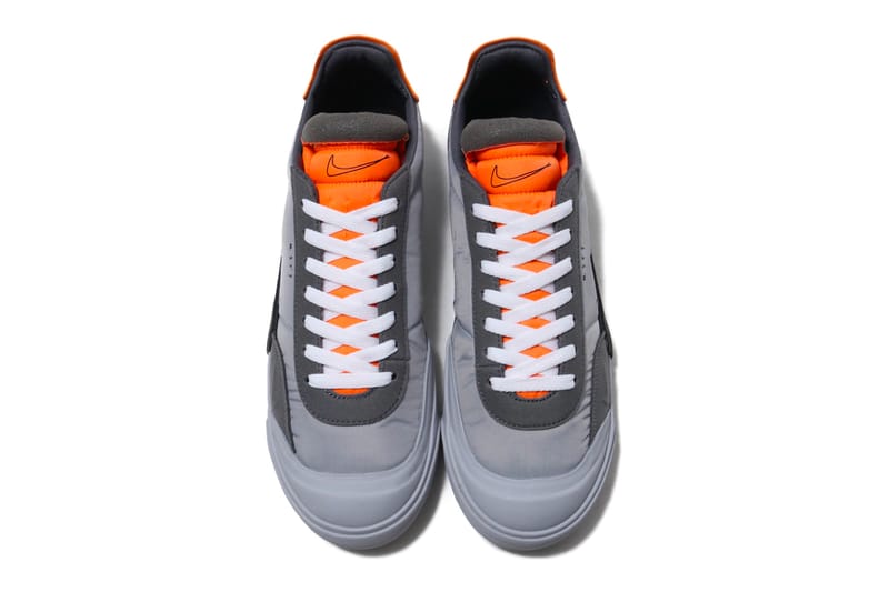 grey nike trainers with orange tick