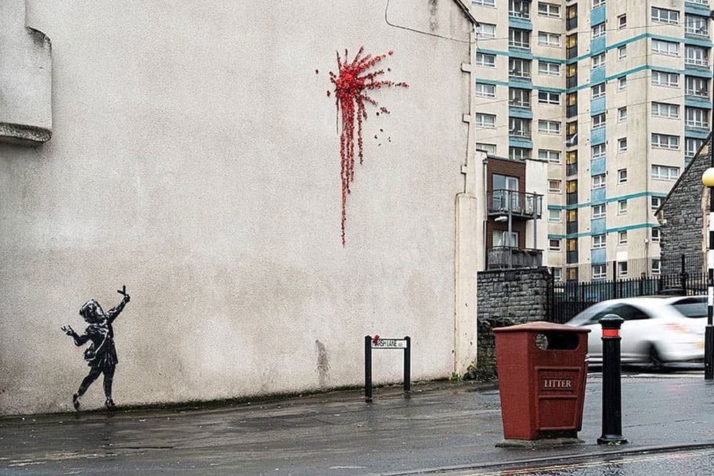 Banksy Unveils Valentine's Day Mural in Bristol Cupid With Slingshot Red Flowers Explosion Wall Spray Painted Ivy Graffiti House Artworks Closer Look