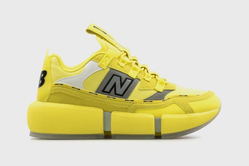 black and yellow new balance shoes