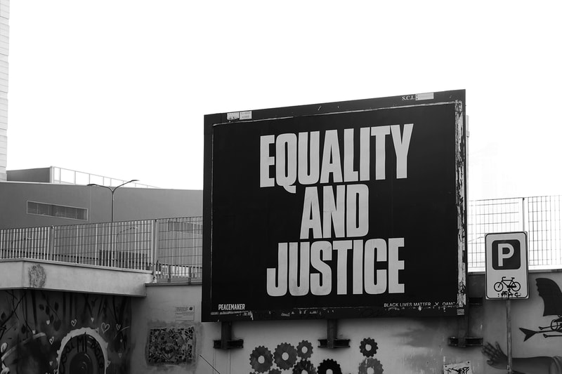OAMC Black Lives Matter Fight Racism anti justice and equality menswear streetwear fall winter 2020 collection billboard campaign photography imagery black and white jacket t shirt