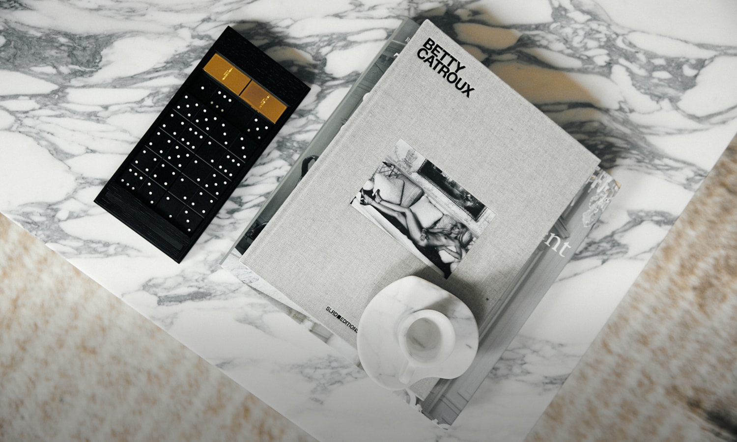 Rive Droite retail space Creative Director Anthony Vaccarello Rive Gauche YSL exclusive products lookbook paris los angeles democratizing luxury fashion GPO boombox SL24 mid top-sneakers gold-tone Betty Catroux book Cube-shaped candle holders hand cut marble crystal-embellished dominoes playing cards palmtree snowglobe cigarette matchbox Self Service 25th anniversary special edition magazine tennis racket Saint Laurent Skateboard 6KU Nebula Bicycle Polaroid SX70 with reflex lens Cotodama Lyric Speaker Neo Legend Retro Arcade Machine