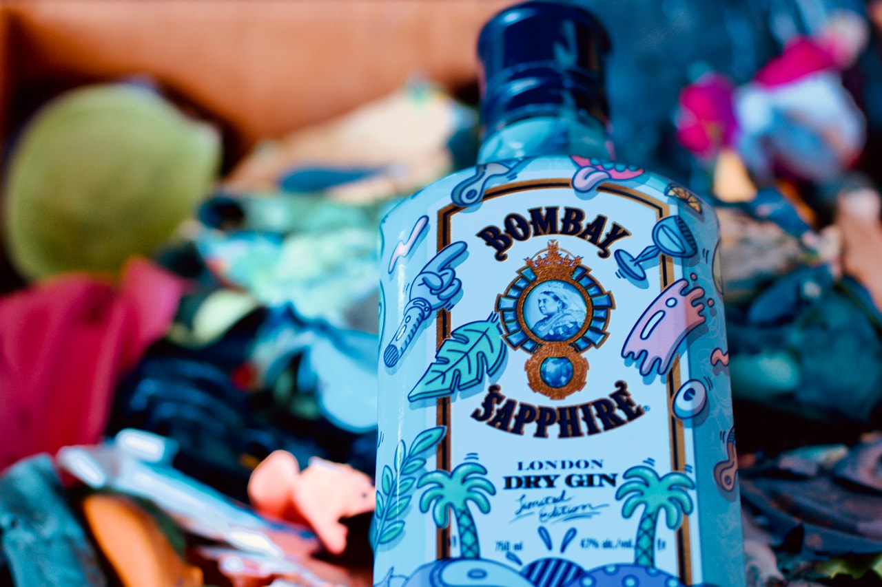 Bombay artist collaboration shoppable lookbook closer look well-infused glass of flavors 10 hand-selected botanicals from exotic locations around the world tongue-in-cheek, inviting graphics and colorful pop latest custom limited-edition lemon peel, almonds for the almond powder and juniper berries playful, vibrant graphics flavor fun Steven Harrington x Bombay Sapphire bottle collaboration $22.99 USD