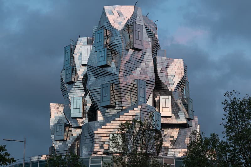 Frank Gehry Unveils Reflective Stainless Steel-Clad Tower in Southern France LUMA Arles france parc des ateliers paris van goh starry night roman amphitheater aluminum france roman arles south of france