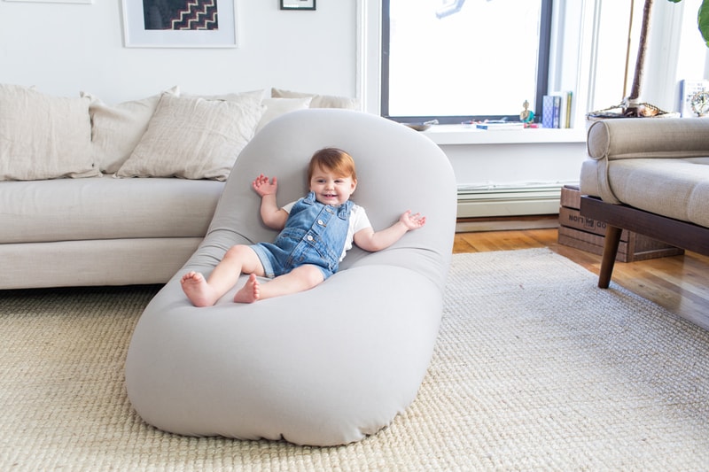 high-end, zero-gravity, relieve stress, anxiety, insomnia, PTSD, and ADHD, floatation therapy, soft stretchy, adaptive flexibility and ergonomically crafted support, 12 pounds and taking up 4 square feet of space, oon Indigo, Cosmic Ash, Space Gray, Neptune Blue, and Rose Quartz colorways high-density beads weightless cloudlike seating dense sleek new bean bag entrepreneur John Fiorentino gravity blanket sustainable manufacturing process versatile supportive fun flexible moon pod 