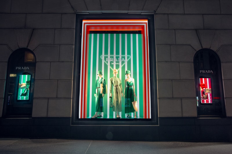 Spring Summer 2022 Collection Prada Tropico Hypnotic Window Light Installation Bergdorf Goodman Department Store Refracted Multicolored Lights Luxury Fashion Experiential Storefront Vertical Diagonal Lines Hues Green Orange Red Bright Vivid Nylon Striped Dresses Blouses Shoes Rubber Sandals Bucket Hats Raffia Handbags Pajama Sets Tropical Rainbow 