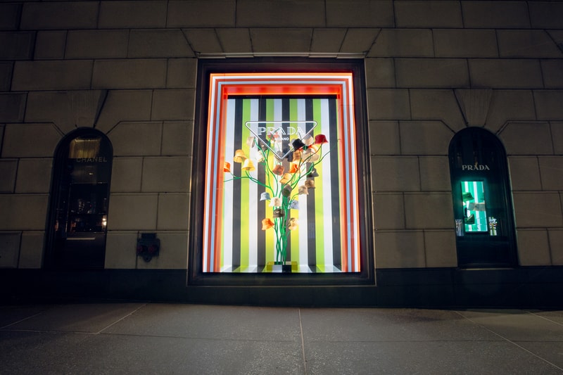 Spring Summer 2022 Collection Prada Tropico Hypnotic Window Light Installation Bergdorf Goodman Department Store Refracted Multicolored Lights Luxury Fashion Experiential Storefront Vertical Diagonal Lines Hues Green Orange Red Bright Vivid Nylon Striped Dresses Blouses Shoes Rubber Sandals Bucket Hats Raffia Handbags Pajama Sets Tropical Rainbow 