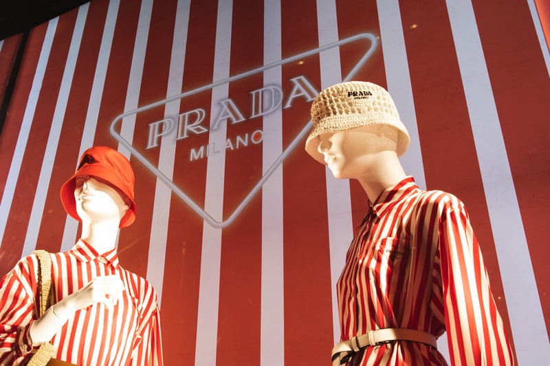 Spring Summer 2022 Collection Prada Tropico Hypnotic Window Light Installation Bergdorf Goodman Department Store Refracted Multicolored Lights Luxury Fashion Experiential Storefront Vertical Diagonal Lines Hues Green Orange Red Bright Vivid Nylon Striped Dresses Blouses Shoes Rubber Sandals Bucket Hats Raffia Handbags Pajama Sets Tropical Rainbow 