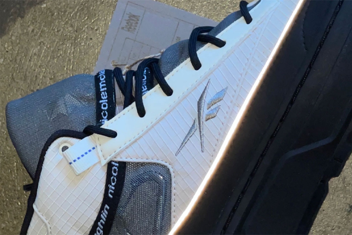 Nicole Mclaughlin Teases Reebok Sneaker Collaboration upcycle white grid nylon mesh caribiner arc teryx reflective piping stacked black sole unit release info