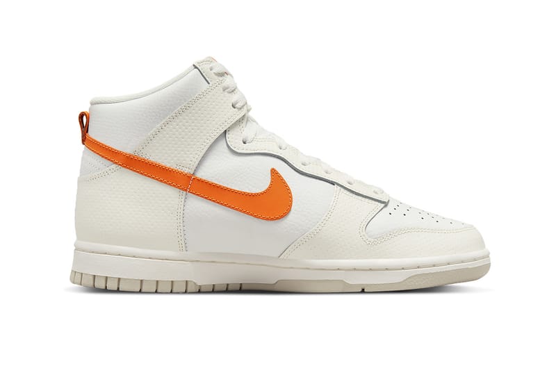 white nikes with orange swoosh