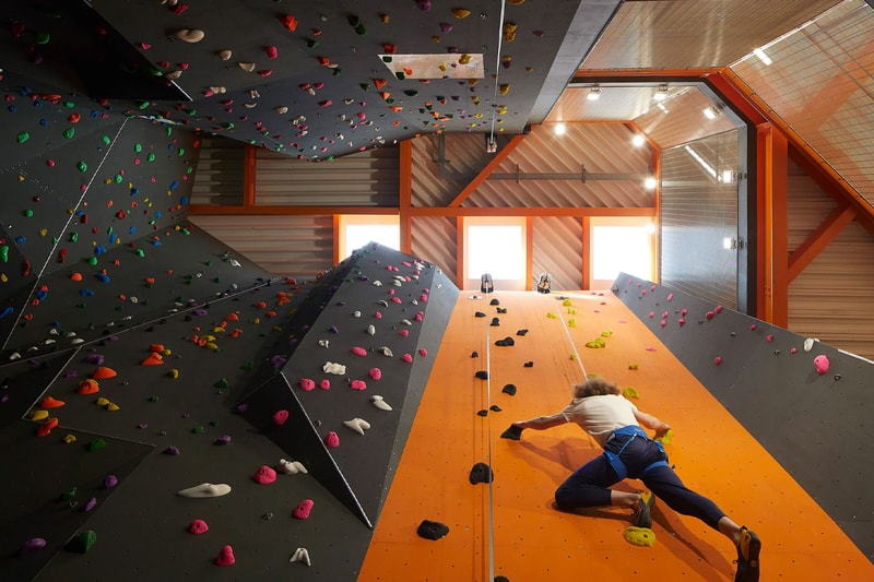 Hollaway Studio Designs the World's First Multi Floor Skatepark climbing wall three stories adrenaline building boxing gym cafe space central hub for youth 