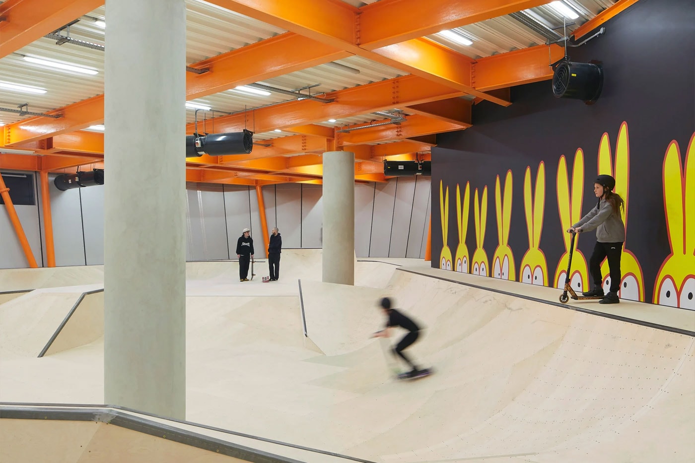 Hollaway Studio Designs the World's First Multi Floor Skatepark climbing wall three stories adrenaline building boxing gym cafe space central hub for youth 