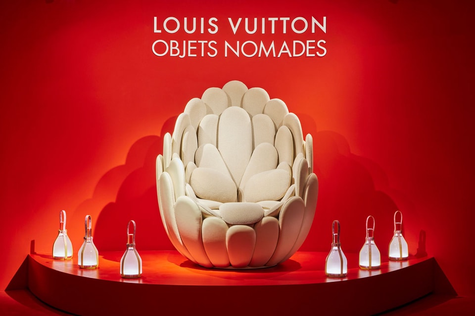 People walk around 'Objets Nomades' installation by Louis Vuitton
