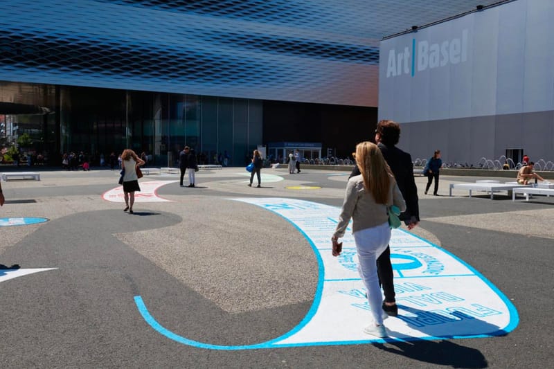 Lawrence Weiner’s ‘OUT OF SIGHT’ Installation Is Being Exhibited at the Entrance of Art Basel