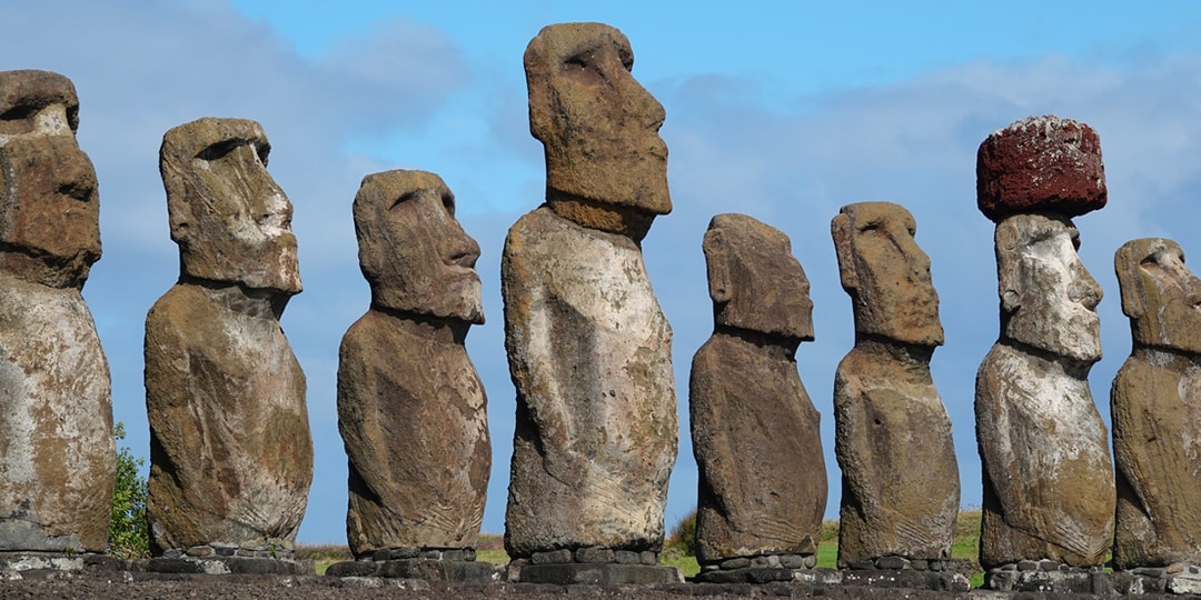 A moai behind a podium giving a speech