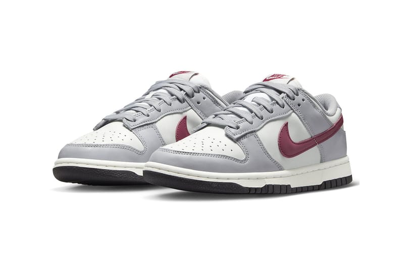 gray nike shoes with red swoosh