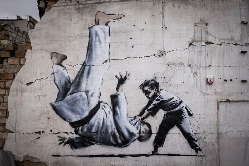 Banksy Ukraine Artwork Borodyanka Graffiti Artist UK Unknown Art Russia Judo Match President Vladimir Putin Seesaw Handstand