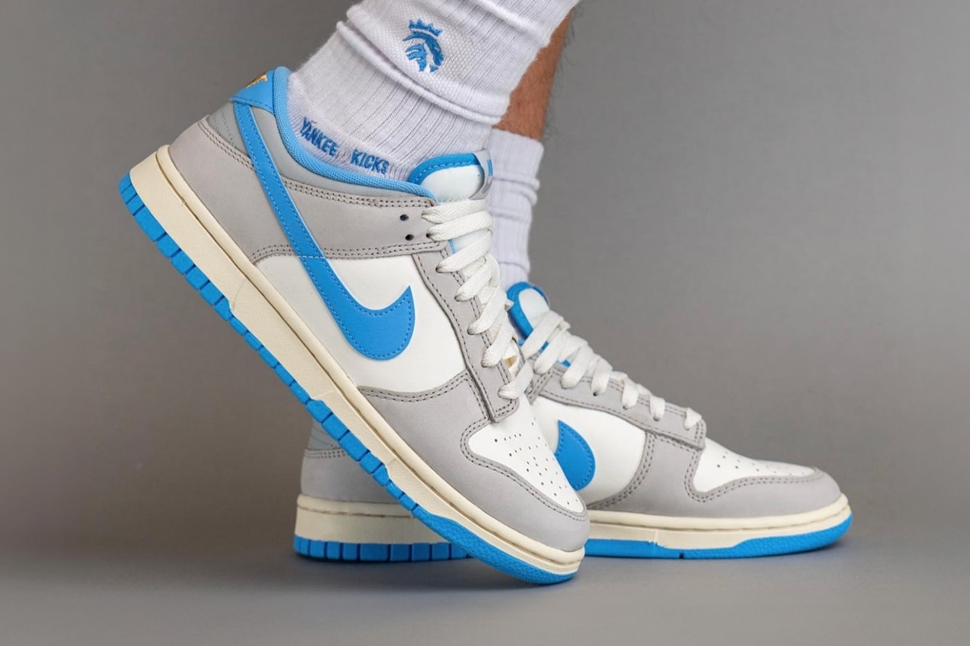 On-Feet Look at the Nike Dunk Low "Athletic Department" FN7488-133 Sail/University Blue-Light Iron Ore-Light Smoke Grey-Coconut Milk sneakers swoosh low top university blue